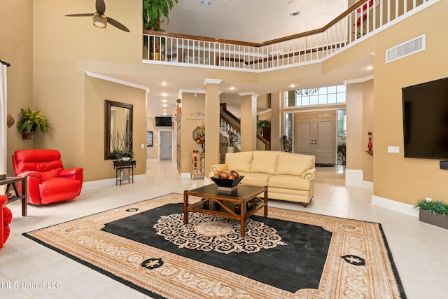 19592 Champion Cir, Gulfport, MS 39503 - living room with a high ceiling, tile patterned flooring, a ceiling fan, baseboards, and stairs