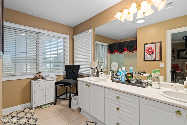 19592 Champion Cir, Gulfport, MS 39503 - full bath with a chandelier, tile patterned floors, double vanity, and baseboards