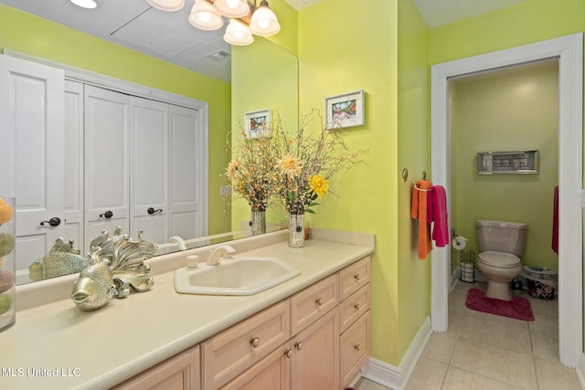 19592 Champion Cir, Gulfport, MS 39503 - bathroom with tile patterned flooring, toilet, vanity, and baseboards