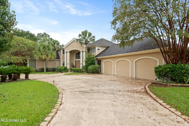 19592 Champion Cir, Gulfport, MS 39503 - view of front facade featuring driveway, a garage, and a front yard