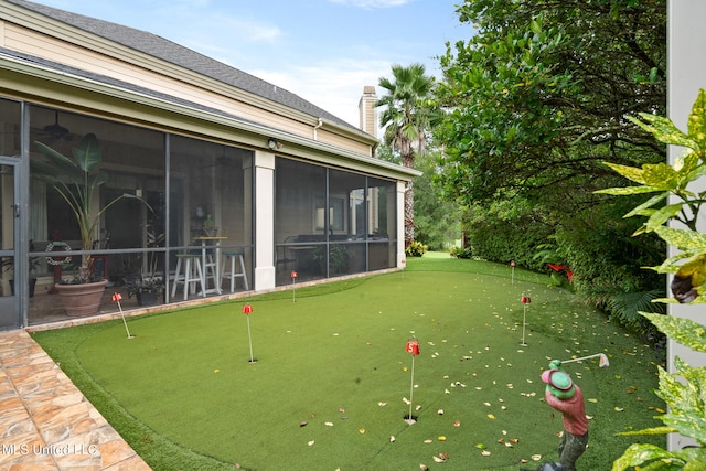 19592 Champion Cir, Gulfport, MS 39503 - view of yard featuring an area to practice putting and a sunroom