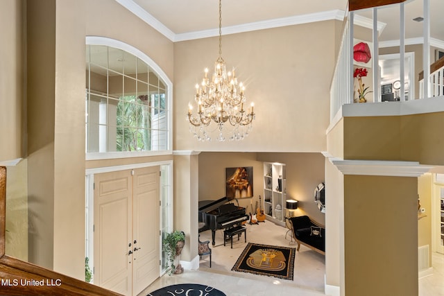 19592 Champion Cir, Gulfport, MS 39503 - foyer entrance featuring a high ceiling, a chandelier, crown molding, and baseboards