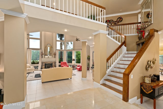 19592 Champion Cir, Gulfport, MS 39503 - stairs featuring a high ceiling, ornamental molding, tile patterned flooring, healthy amount of natural light, and ceiling fan