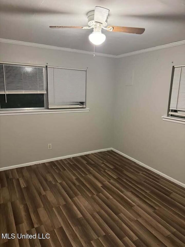 spare room with a ceiling fan, baseboards, crown molding, and wood finished floors