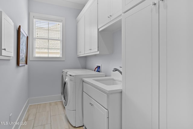 washroom with washer and dryer, sink, cabinets, and light tile patterned flooring