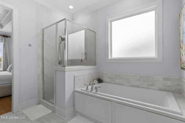 bathroom featuring separate shower and tub