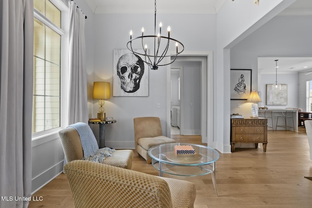 living area with light hardwood / wood-style flooring and a notable chandelier