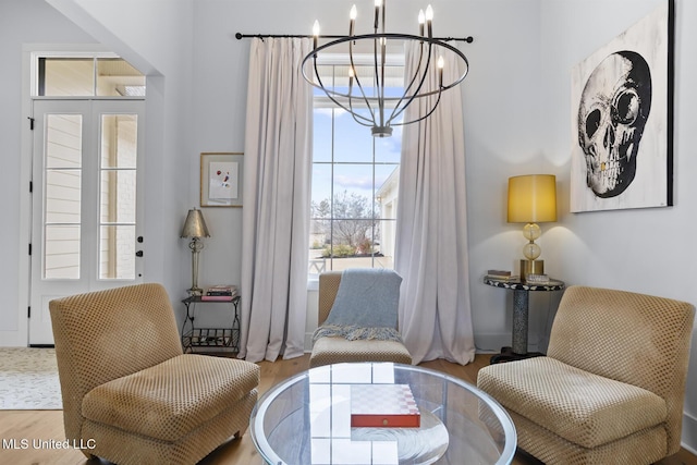 sitting room featuring hardwood / wood-style flooring and a notable chandelier