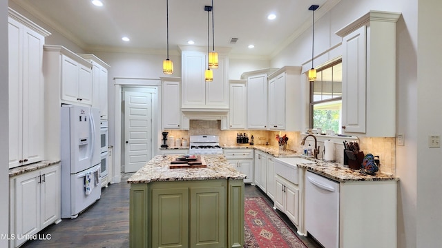 kitchen with white cabinetry, hanging light fixtures, dark hardwood / wood-style flooring, white appliances, and a kitchen island