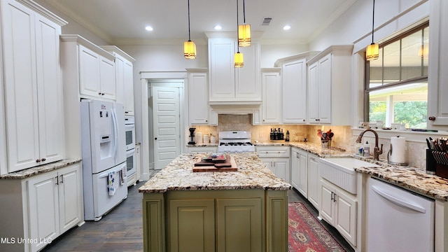 kitchen with a center island, white cabinets, hanging light fixtures, and white appliances