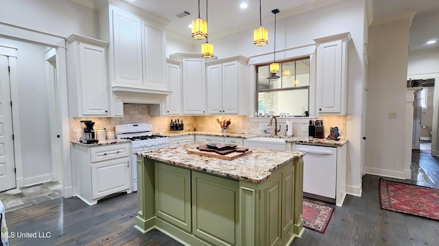 kitchen with light stone counters, white appliances, dark wood-type flooring, a center island, and green cabinets