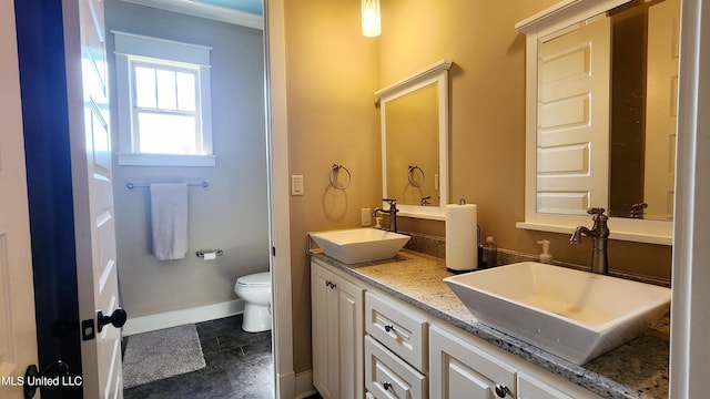 bathroom featuring tile patterned floors, vanity, toilet, and crown molding