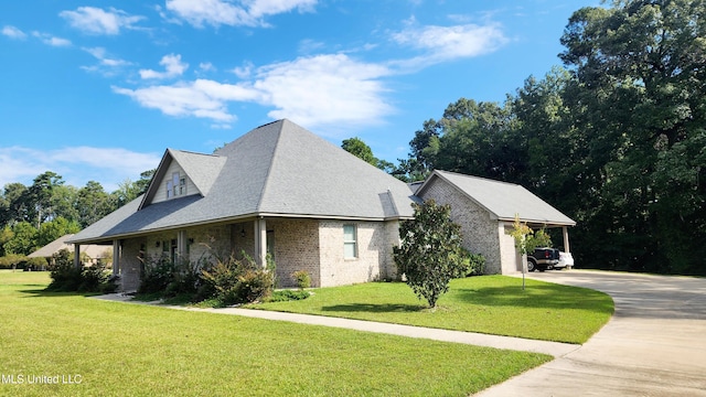 view of side of home with a lawn and a carport