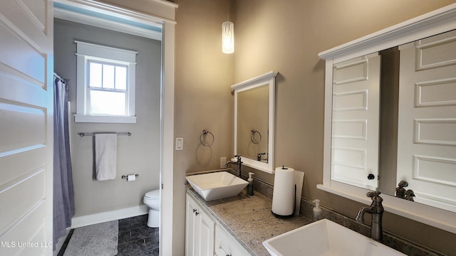 bathroom featuring vanity and toilet