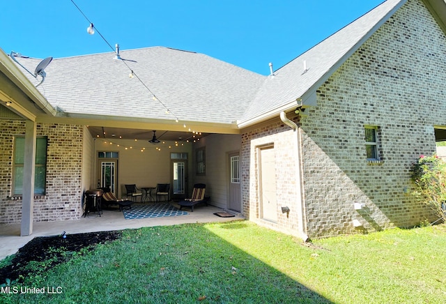 back of property featuring a lawn and a patio