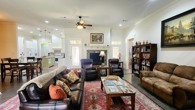 living room with ceiling fan, wood-type flooring, and ornamental molding