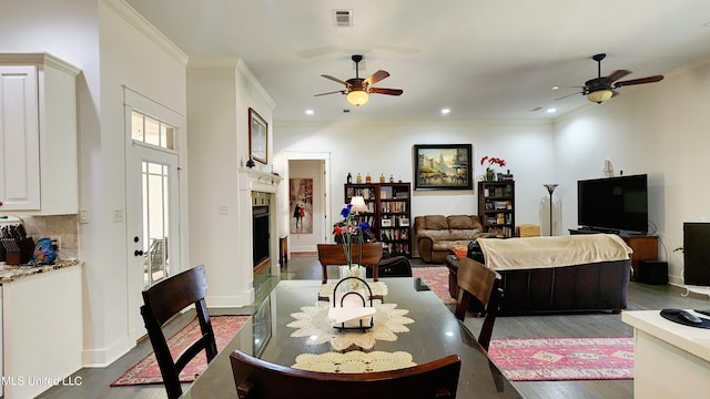 living room with ceiling fan, dark hardwood / wood-style floors, and ornamental molding