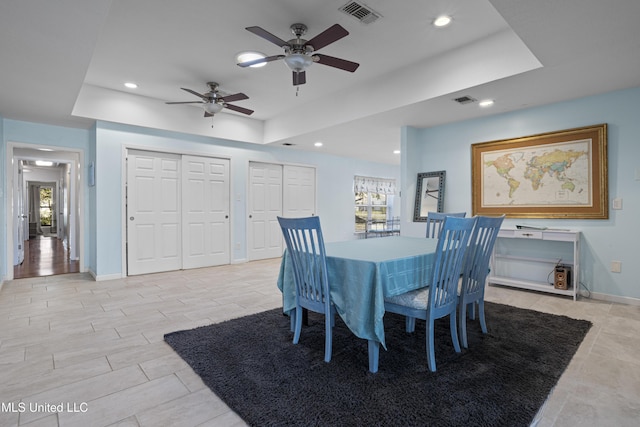 dining space featuring visible vents, a raised ceiling, and recessed lighting