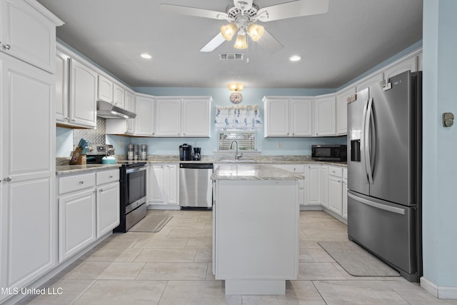 kitchen with under cabinet range hood, a sink, white cabinetry, visible vents, and appliances with stainless steel finishes