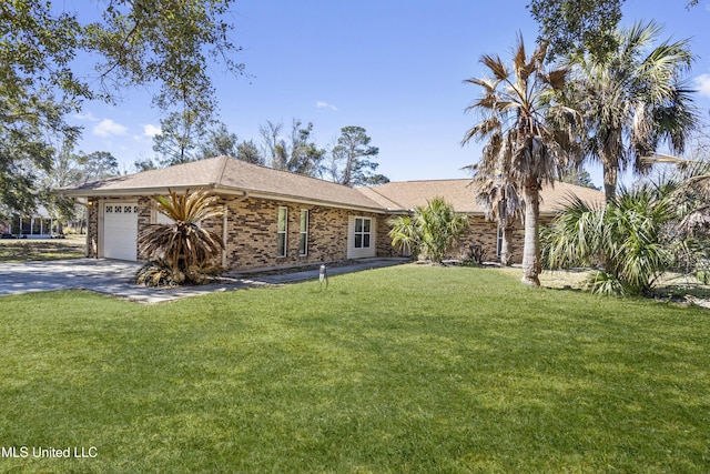 ranch-style house featuring a front yard, concrete driveway, brick siding, and an attached garage