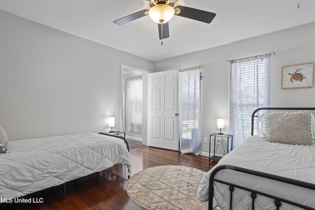 bedroom with a ceiling fan, baseboards, and wood finished floors