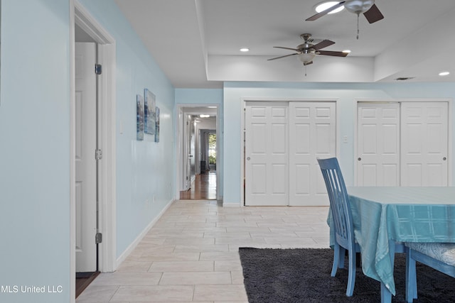 unfurnished dining area featuring baseboards, wood finish floors, a ceiling fan, and recessed lighting