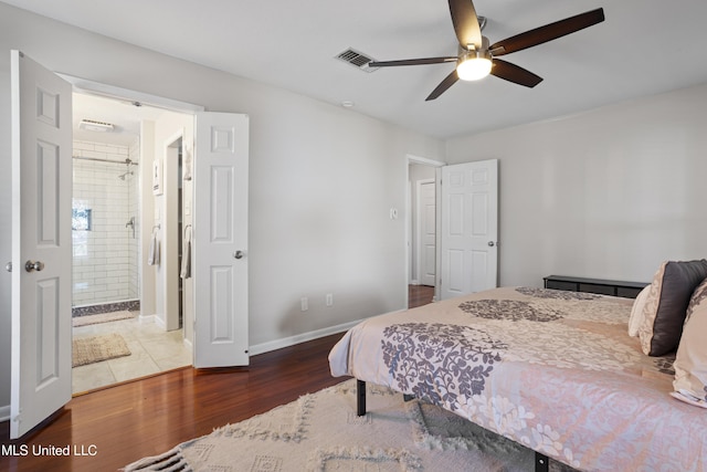 bedroom featuring ceiling fan, connected bathroom, wood finished floors, visible vents, and baseboards