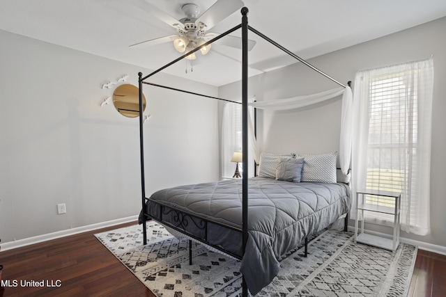 bedroom featuring a ceiling fan, baseboards, and wood finished floors