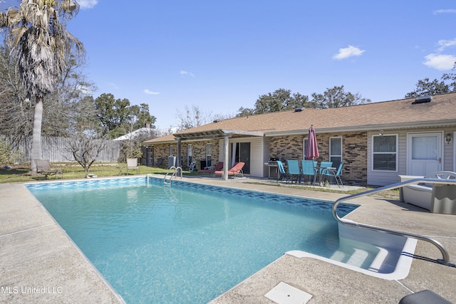 view of swimming pool featuring fence, a fenced in pool, and a patio