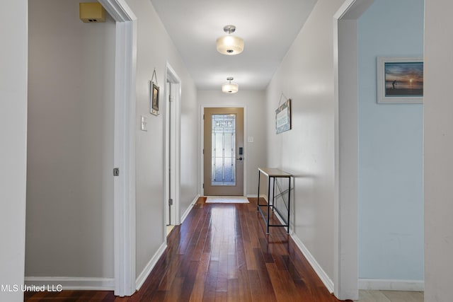 entryway with baseboards and hardwood / wood-style floors