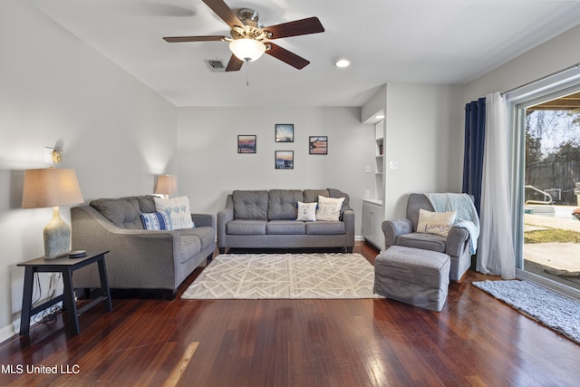 living area featuring a ceiling fan, wood-type flooring, and visible vents