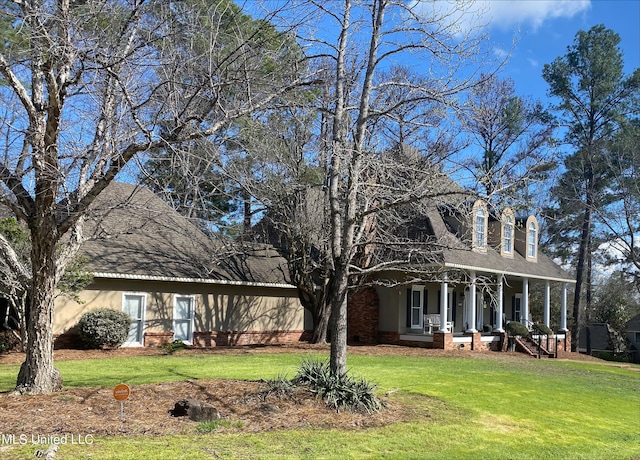 cape cod house with a front lawn and covered porch