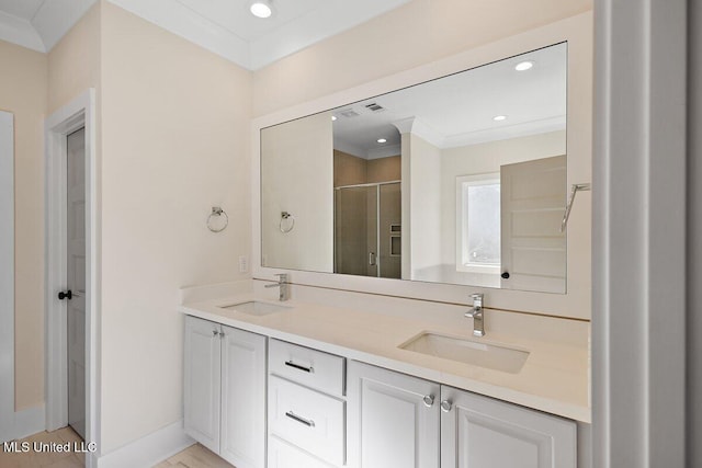 full bath featuring recessed lighting, a sink, a shower stall, and double vanity