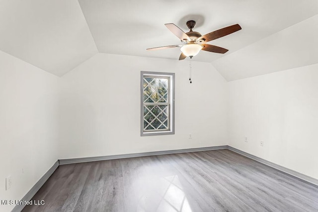 additional living space with ceiling fan, vaulted ceiling, and light hardwood / wood-style flooring