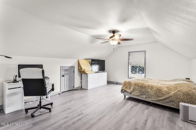 bedroom with wood-type flooring, a textured ceiling, ceiling fan, and lofted ceiling