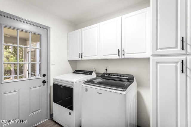 washroom featuring washer and dryer, cabinets, and dark wood-type flooring