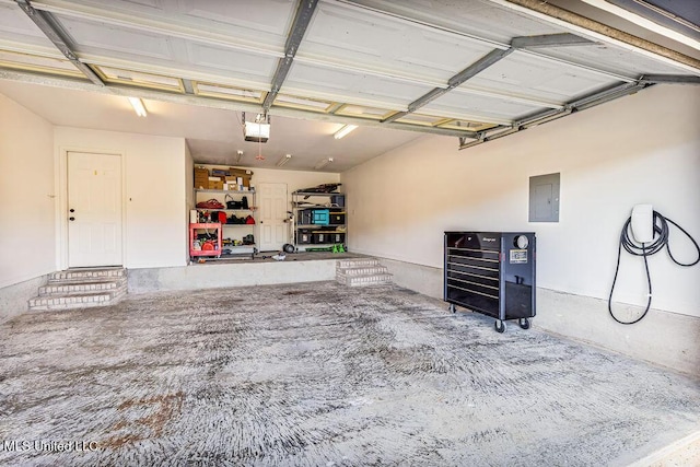 garage with electric panel and a garage door opener