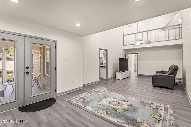 living room featuring ceiling fan, french doors, and hardwood / wood-style flooring