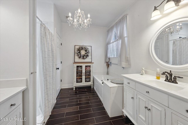 bathroom featuring vanity, a tub to relax in, and an inviting chandelier