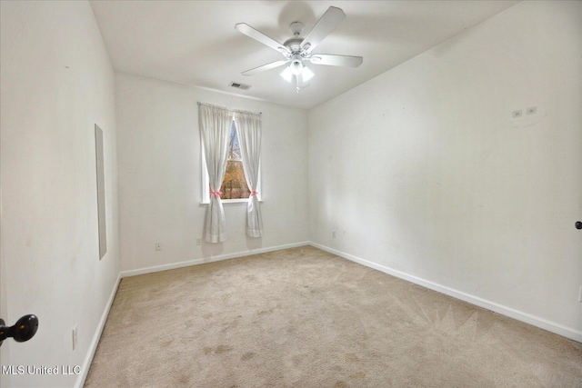 carpeted empty room featuring ceiling fan