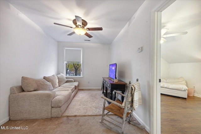 living room featuring ceiling fan, wood-type flooring, and vaulted ceiling