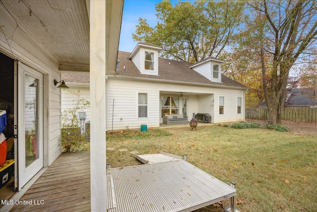 back of house with a lawn, ceiling fan, and a deck