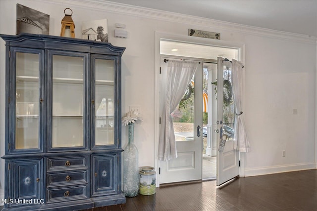 doorway to outside with crown molding and dark wood-type flooring