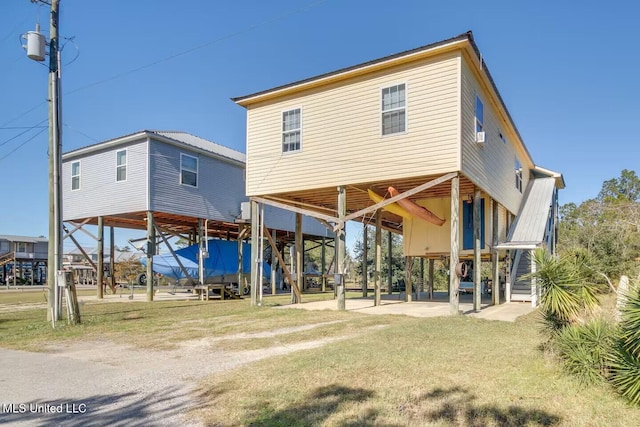 back of property featuring a carport and a patio area