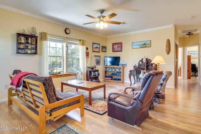 living area featuring light wood-style floors, visible vents, and ornamental molding