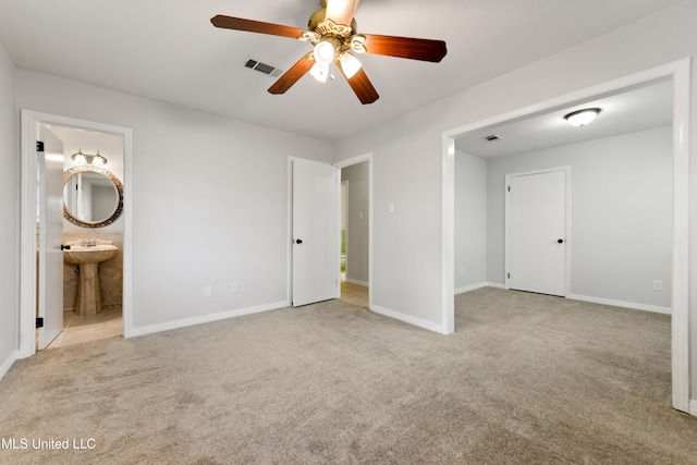 unfurnished bedroom with visible vents, carpet flooring, baseboards, and ensuite bath