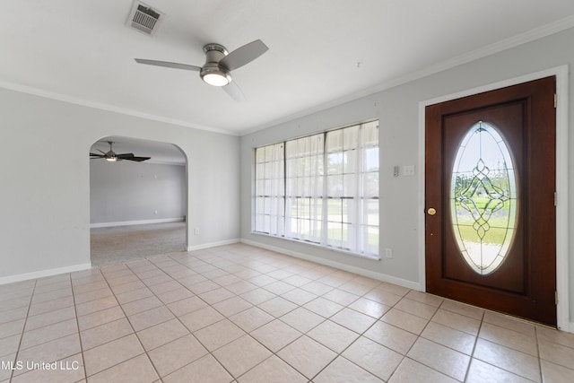 foyer entrance with visible vents, crown molding, baseboards, ceiling fan, and light tile patterned floors