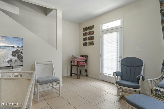 sitting room with light tile patterned floors and baseboards