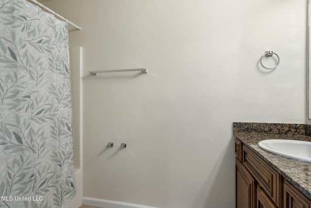 bathroom featuring vanity and shower / bathtub combination with curtain