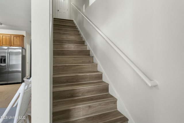 stairway featuring wood finished floors